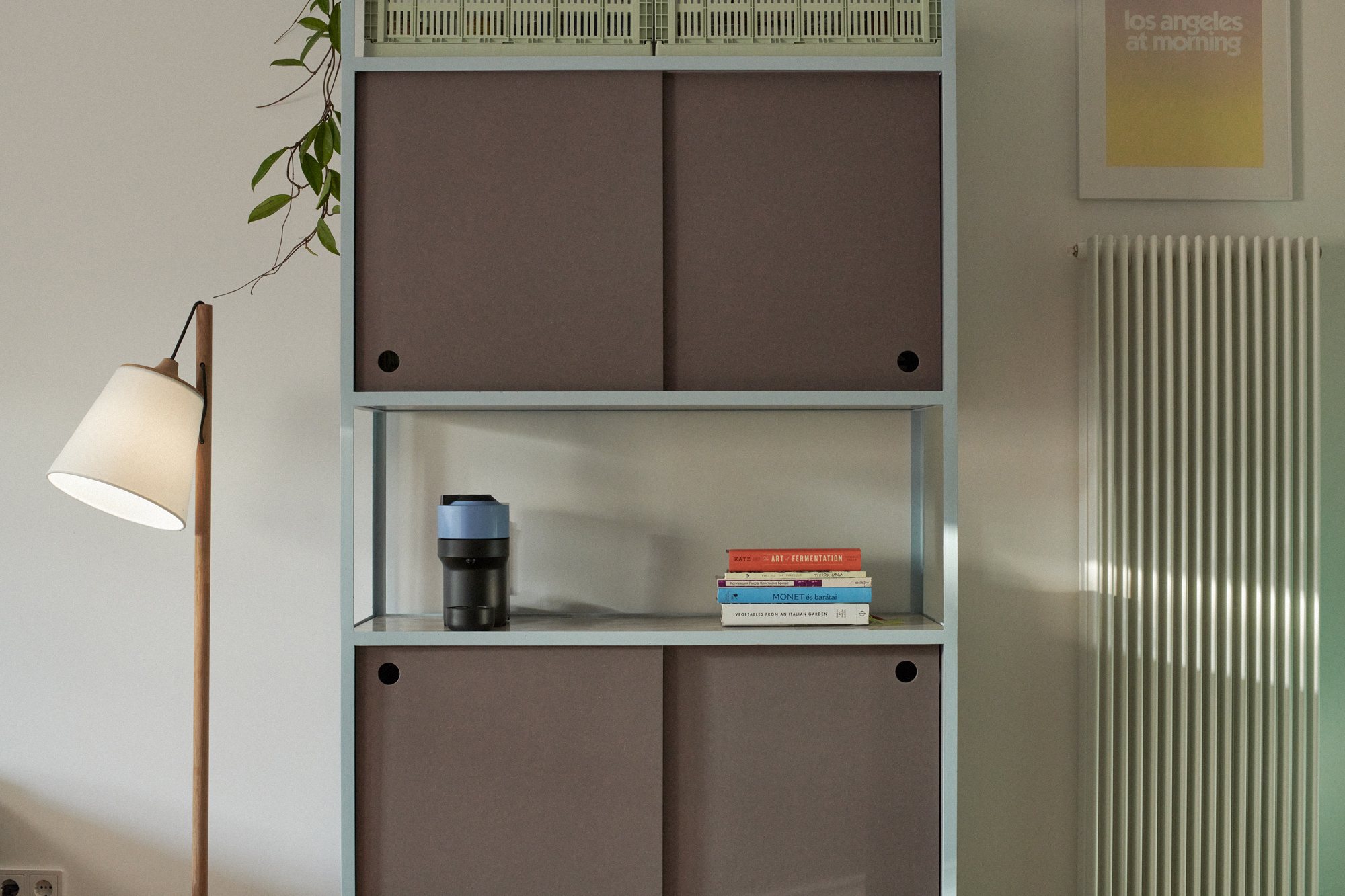 Frame Shelf detail: sliding doors and open shelf beside a floor lamp