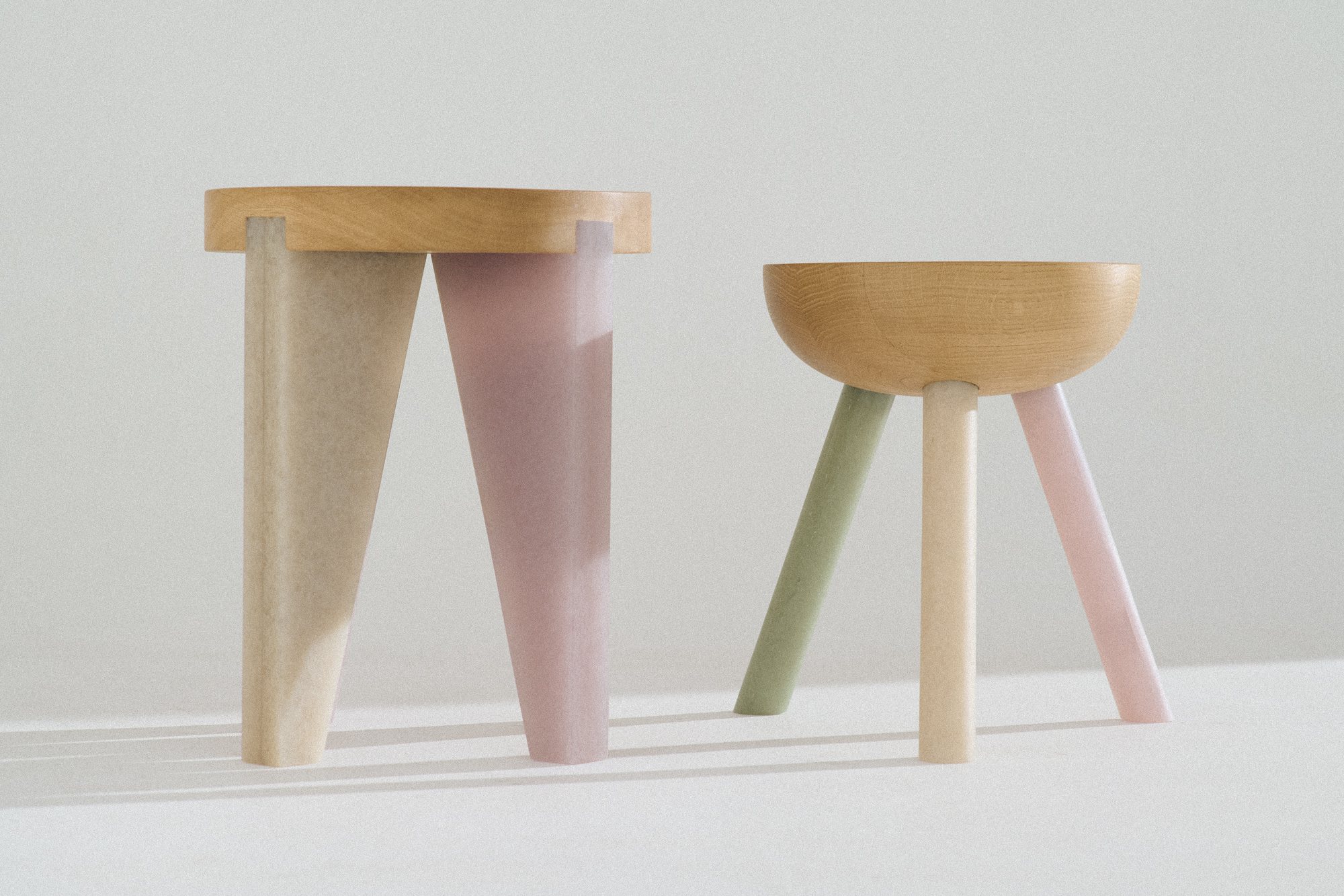 Two NANO Stools: a tall one with pink legs and a low one with green legs