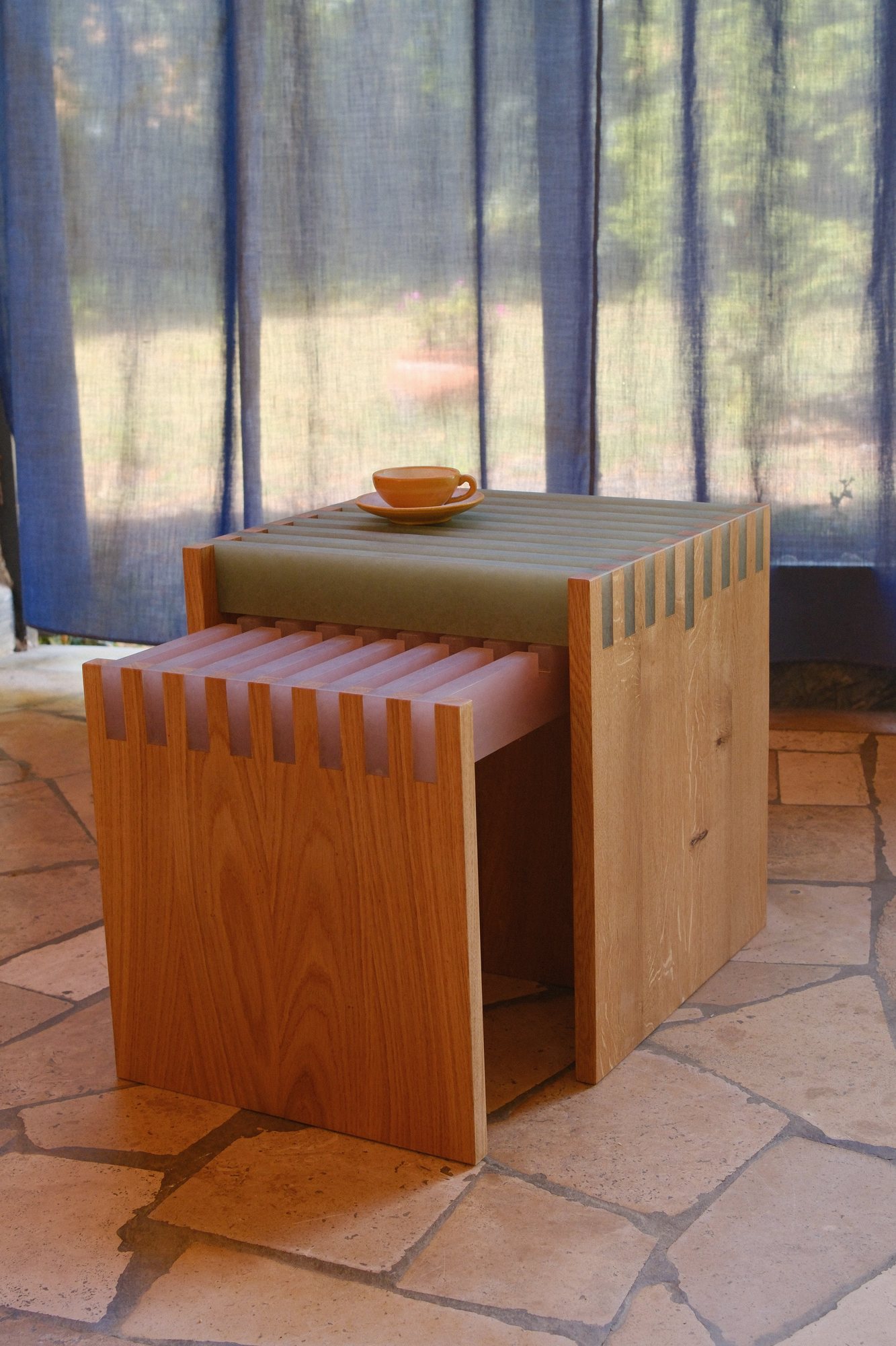 Two SML Cubes nested together on a stone floor