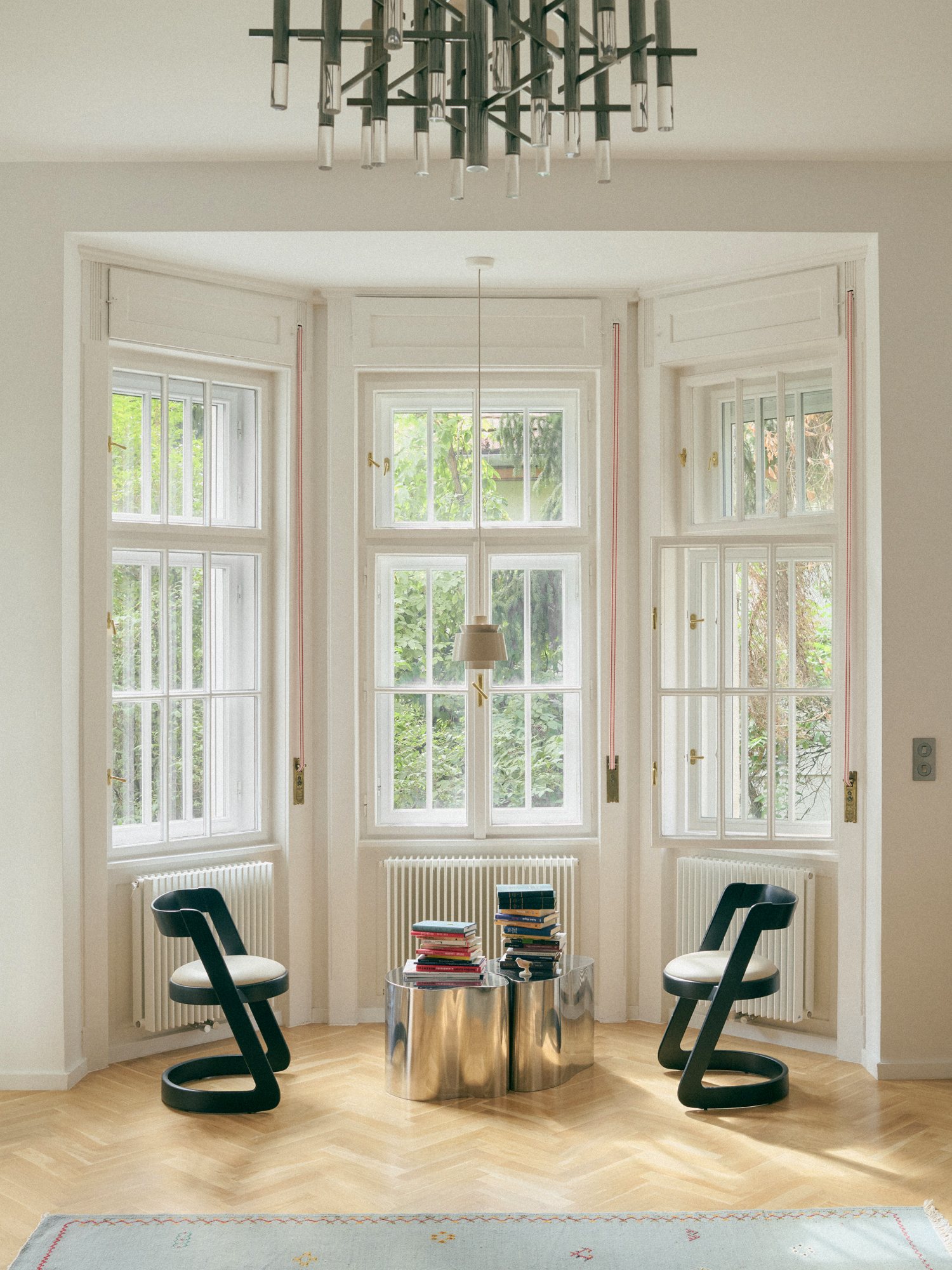 B6 apartment: bay window with two sculptural chairs