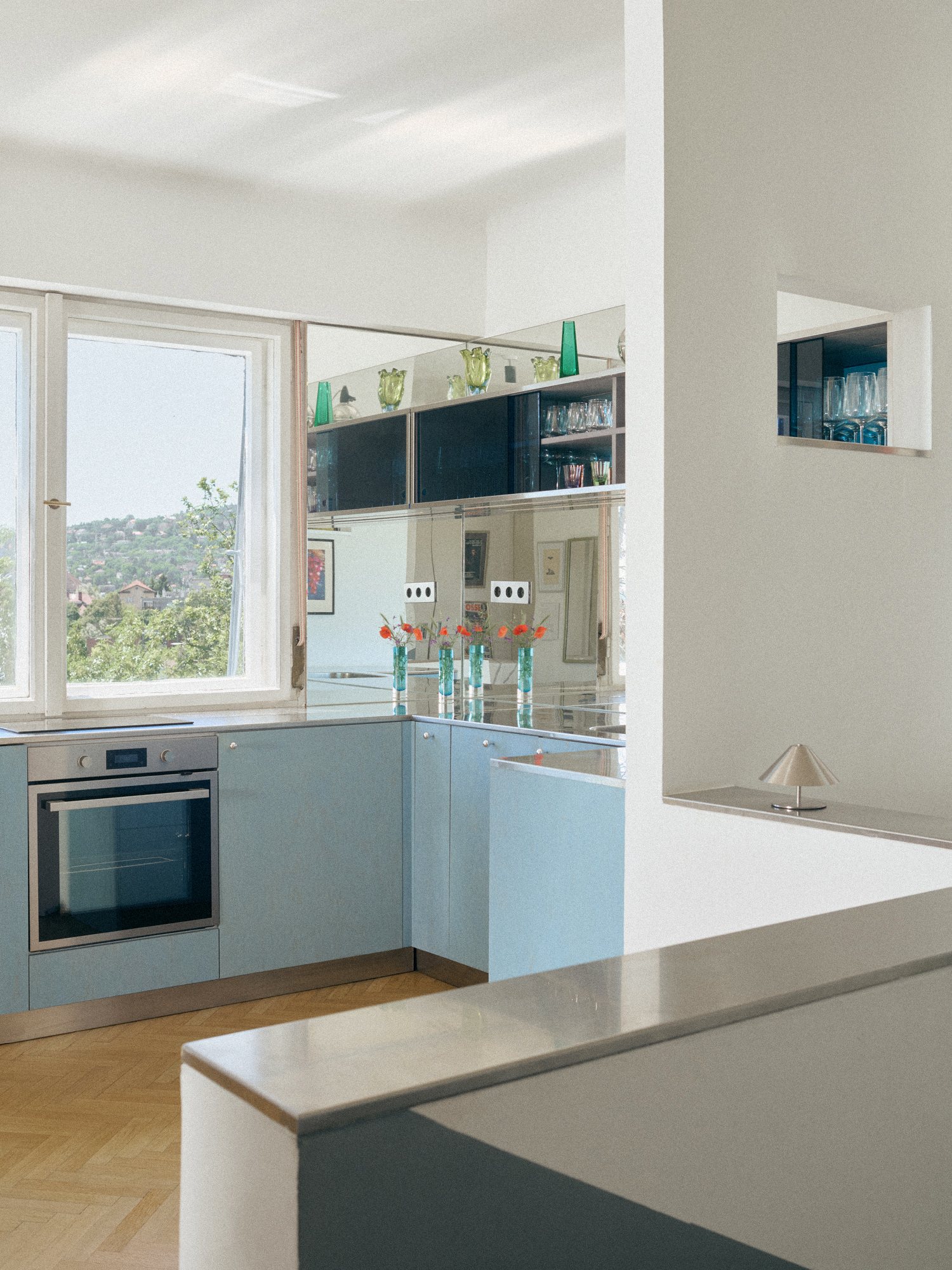 B75 kitchen: powder-blue cabinetry beside a large window