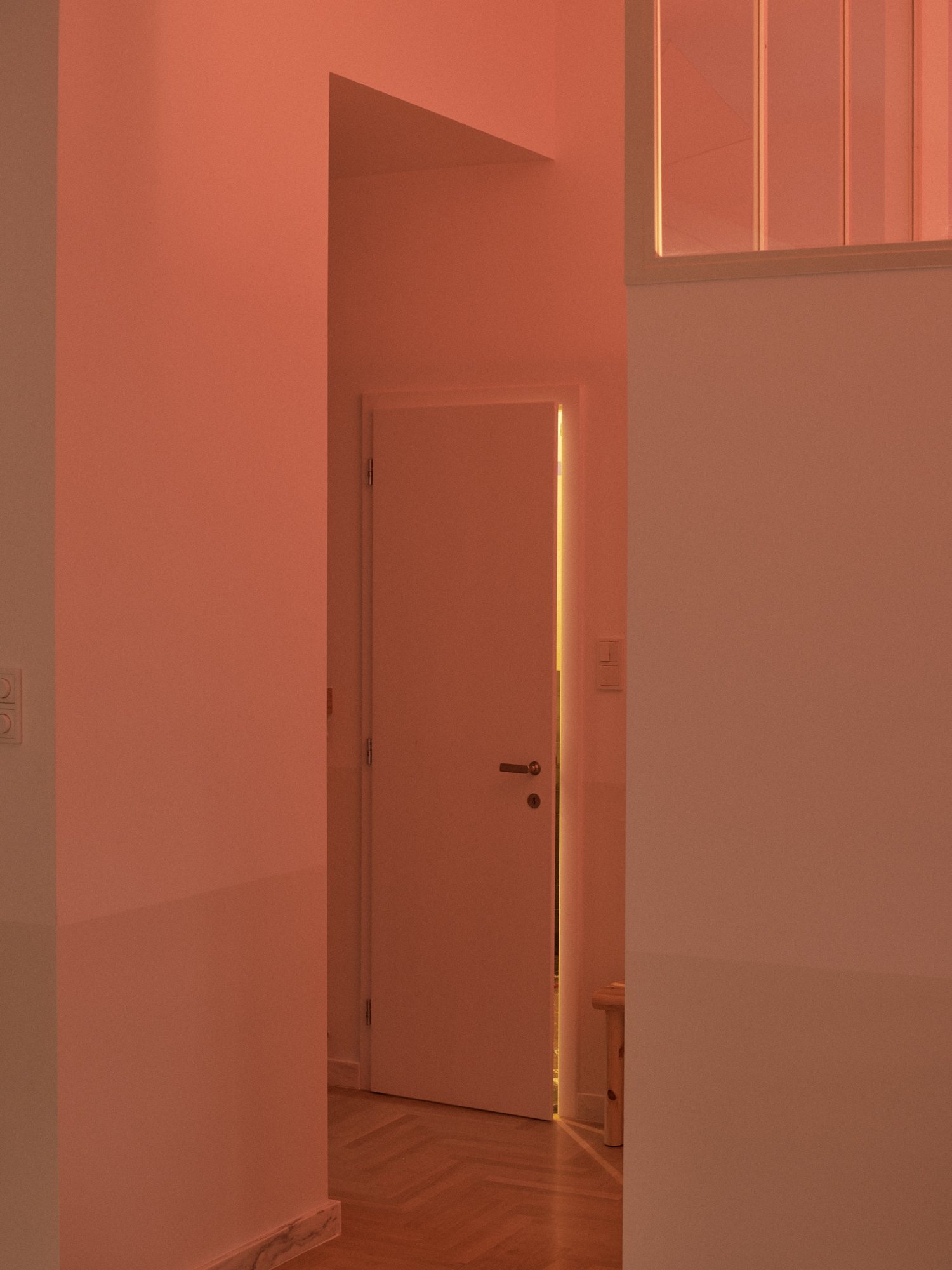 E6 apartment: hallway painted in warm coral